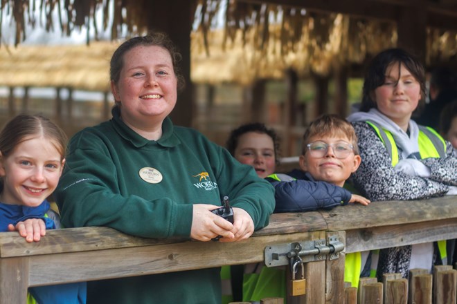 Woburn Safari Educational ranger smiles with workshop children aged around 9 years old