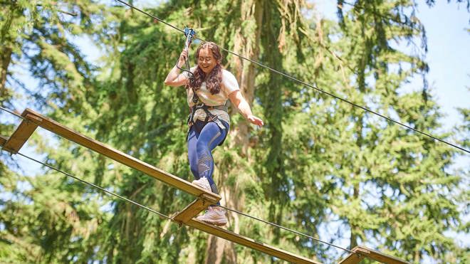 Image of girl taking on treetop challenge web landscape 1920x1080