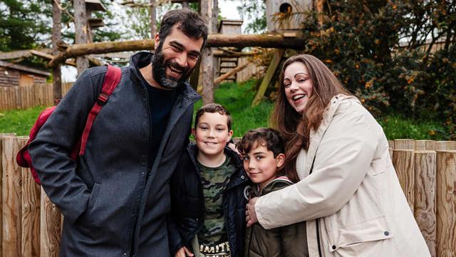 A family at Woburn Safari Park looking at the camera and smiling