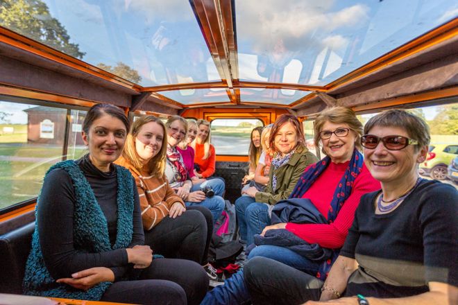 Group inside glass top Bigfoot VIP Safari Vehicle 